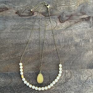 Double strand white beaded and yellow stone teardrop necklace on gold tone chain
